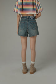 Asymmetrical Button Distressed Denim Shorts